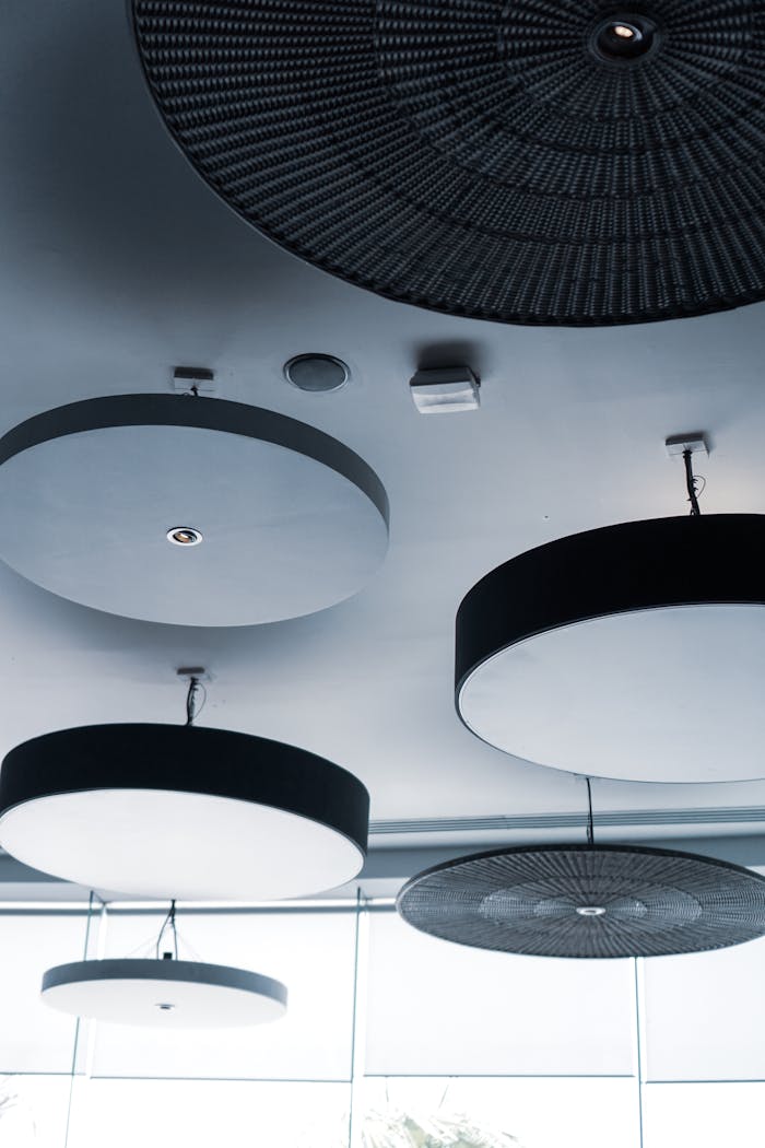 services-03 Circular ceiling lights in a modern design setting, showcasing contemporary lighting aesthetics.